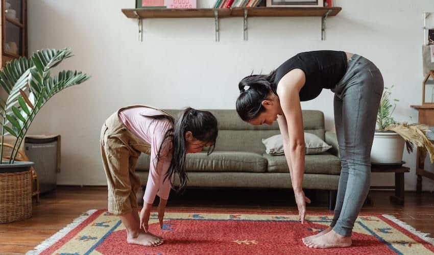 Photo of Woman and Girl Stretching Their Body