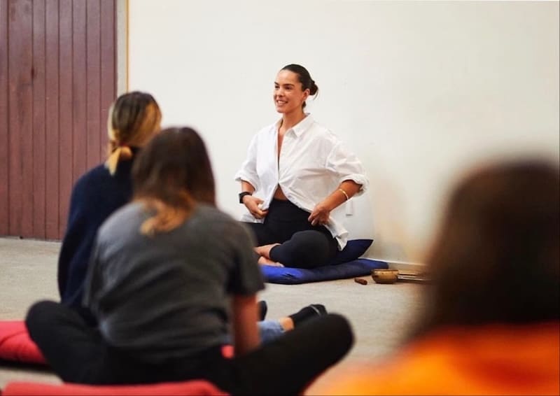 Mindfulness instructor facilitating a group meditation session