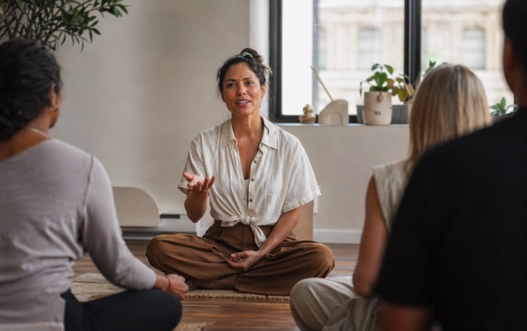 meditation guide speaking calmly to a group during a session meditation guide speaking calmly to a group during a session